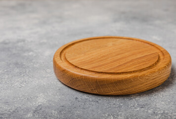 Cutting board on gray kitchen table texture background. Recipe. Kitchenware. Empty modern wooden cutting board. MOCKUP. Place for text. Place to copy.