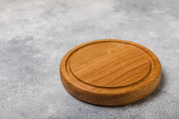 Cutting board on gray kitchen table texture background. Recipe. Kitchenware. Empty modern wooden cutting board. MOCKUP. Place for text. Place to copy.