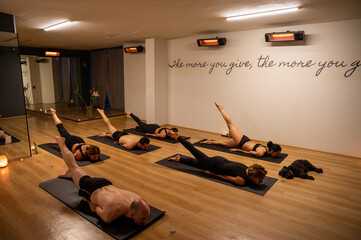 Group of people practicing yoga in studio