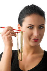 portrait of a cute woman with a gold necklace between red chopstick