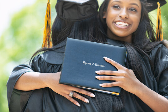 Grad: Friends Embrace After Graduating