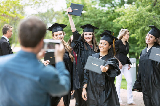 Grad: Father Takes Photo Of Girl With Friends
