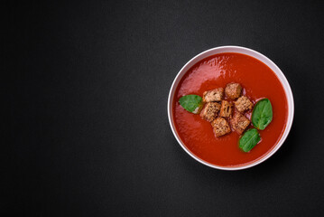 Delicious fresh gazpacho with breadcrumbs, salt and spices in a ceramic plate
