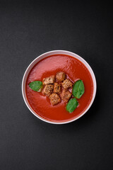 Delicious fresh gazpacho with breadcrumbs, salt and spices in a ceramic plate