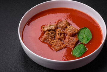 Delicious fresh gazpacho with breadcrumbs, salt and spices in a ceramic plate