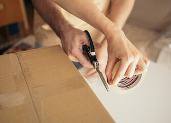 Couple preparing the shipment of clothes from their online store