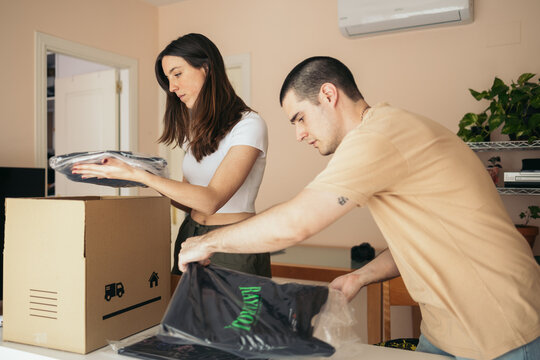 Couple preparing the shipment of clothes from their online store