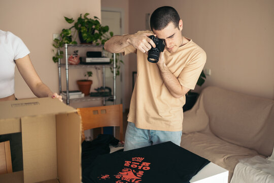 Man preparing the shipment of clothes from his online store
