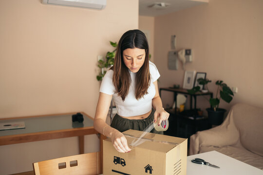Woman preparing the shipment of clothes from her online store