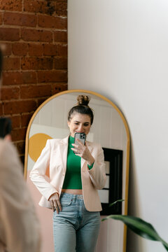 confident woman ready to go out taking selfie