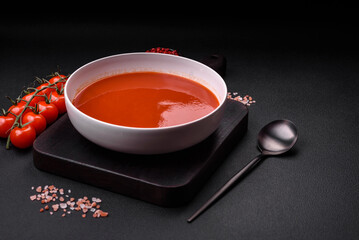 Delicious fresh gazpacho with breadcrumbs, salt and spices in a ceramic plate