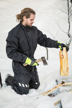 Man chopping wood in snow