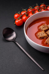 Delicious fresh gazpacho with breadcrumbs, salt and spices in a ceramic plate