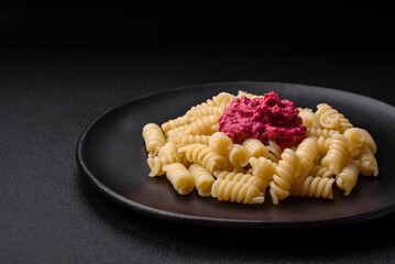 Delicious fusilli pasta with beetroot pesto, parmesan, salt and spices