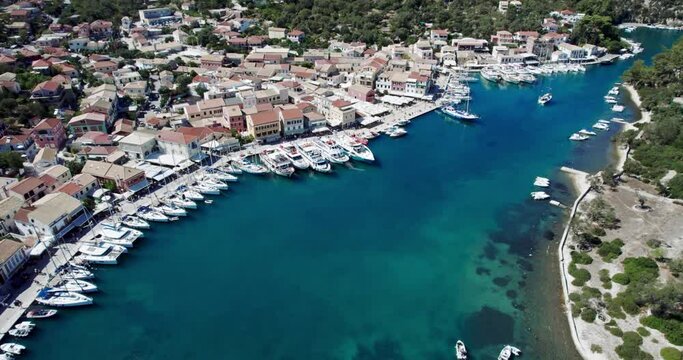 Aerial drone video of iconic port of Gaios a natural fjord bay ideal for safe anchorage in island of Paxos, Ionian, Greece