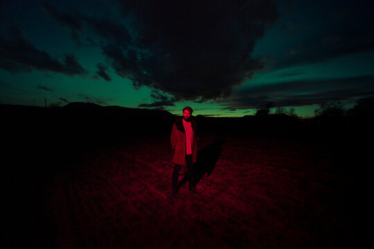 Standing man in surreal dark nature scenery