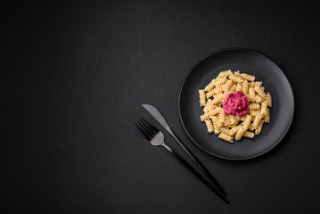 Delicious fusilli pasta with beetroot pesto, parmesan, salt and spices