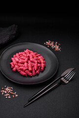 Delicious fusilli pasta with beetroot pesto, parmesan, salt and spices