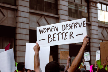 Protest sign Reads "Women Deserve Better" 