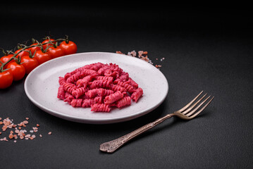 Delicious fusilli pasta with beetroot pesto, parmesan, salt and spices