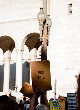 Protester Holding Sign that Reads "Fuck This" 