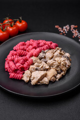 Delicious fusilli pasta with beetroot pesto, parmesan, salt and spices
