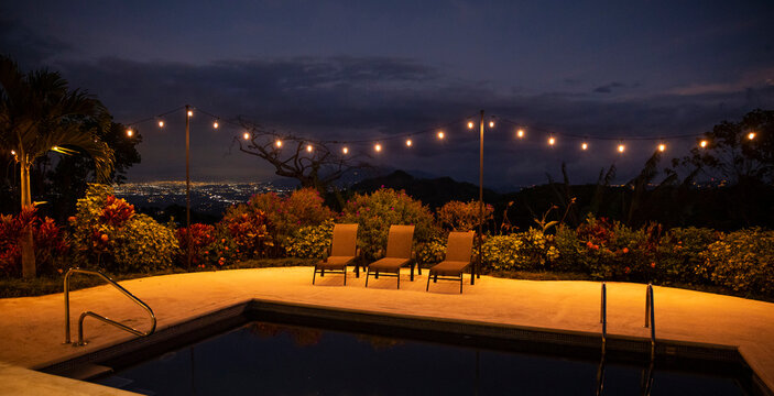String lights around swimming pool sunset landscape in Costa Rica 