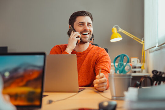Cheerful young man talking on smartphone