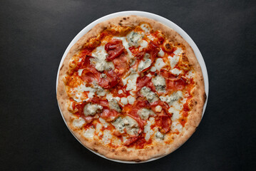 Pizza top view on dark background