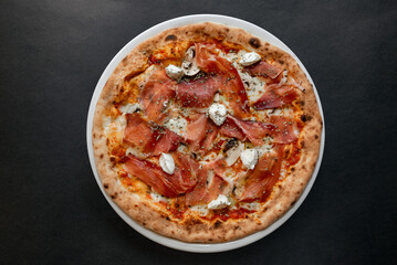 Pizza top view on dark background