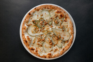 Pizza top view on dark background