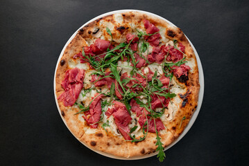 Pizza top view on dark background