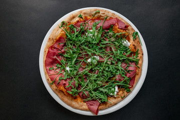 Pizza top view on dark background