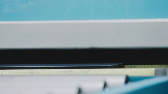 The glass goes into the machine on rollers and goes through the tempering process