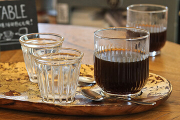 Drip coffee in a glass on a table in a cafe