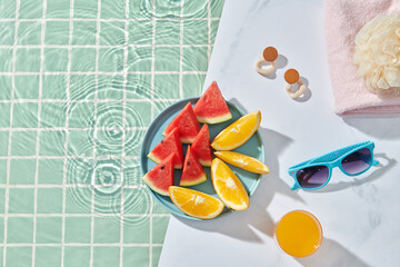Plate with tropical fruits near the pool