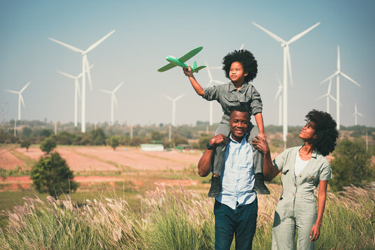 African american family in the community with wind generators turbines, Wind turbines are alternative electricity sources, the concept of sustainable resources and Renewable energy wind turbines farm