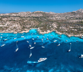 Aerial view of luxury yachts and boats on blue sea at summer sunny day. Travel in Sardinia, Italy....