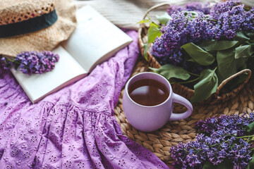 Cup of hot tea and lilac bouquet, good morning concept