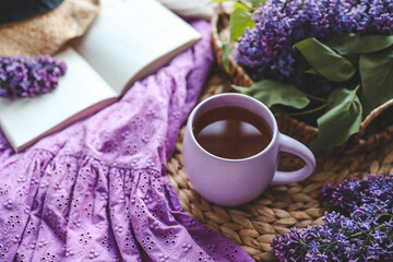 Cup of hot tea and lilac bouquet, good morning concept