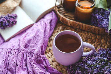 Cup of hot tea and lilac bouquet, good morning concept