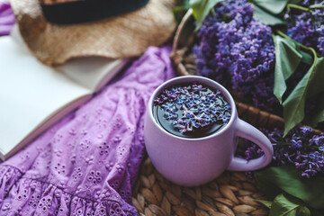 Cup of hot tea and lilac bouquet, good morning concept