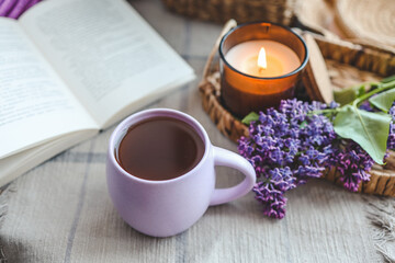 Cup of tea, straw hat and lilac basket, spring still life
