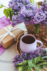 Cup of tea, gift box and lilac basket, spring still life