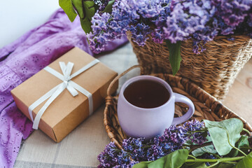 Cup of tea, gift box and lilac basket, spring still life