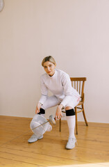 young  blond woman with fencing uniform