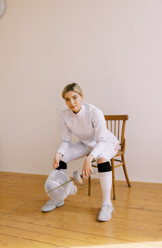 young  blond woman with fencing uniform