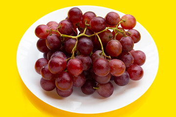 Fresh grape on yellow background.