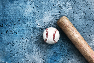 Old grunge texture background with flat lay of wooden baseball bat and ball with copy space for sport game concept.