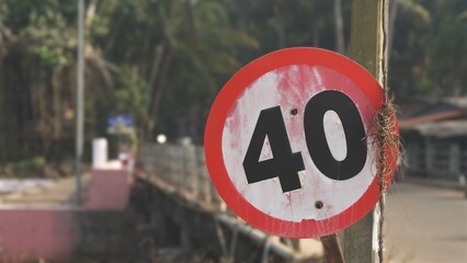 red and white speed limit sign of 40 before the bridge